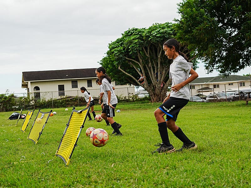 image of young soccer players practicing goals